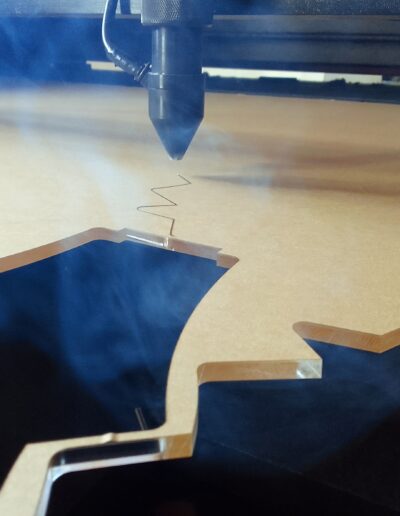 laser cutting acrylic with fumes rising