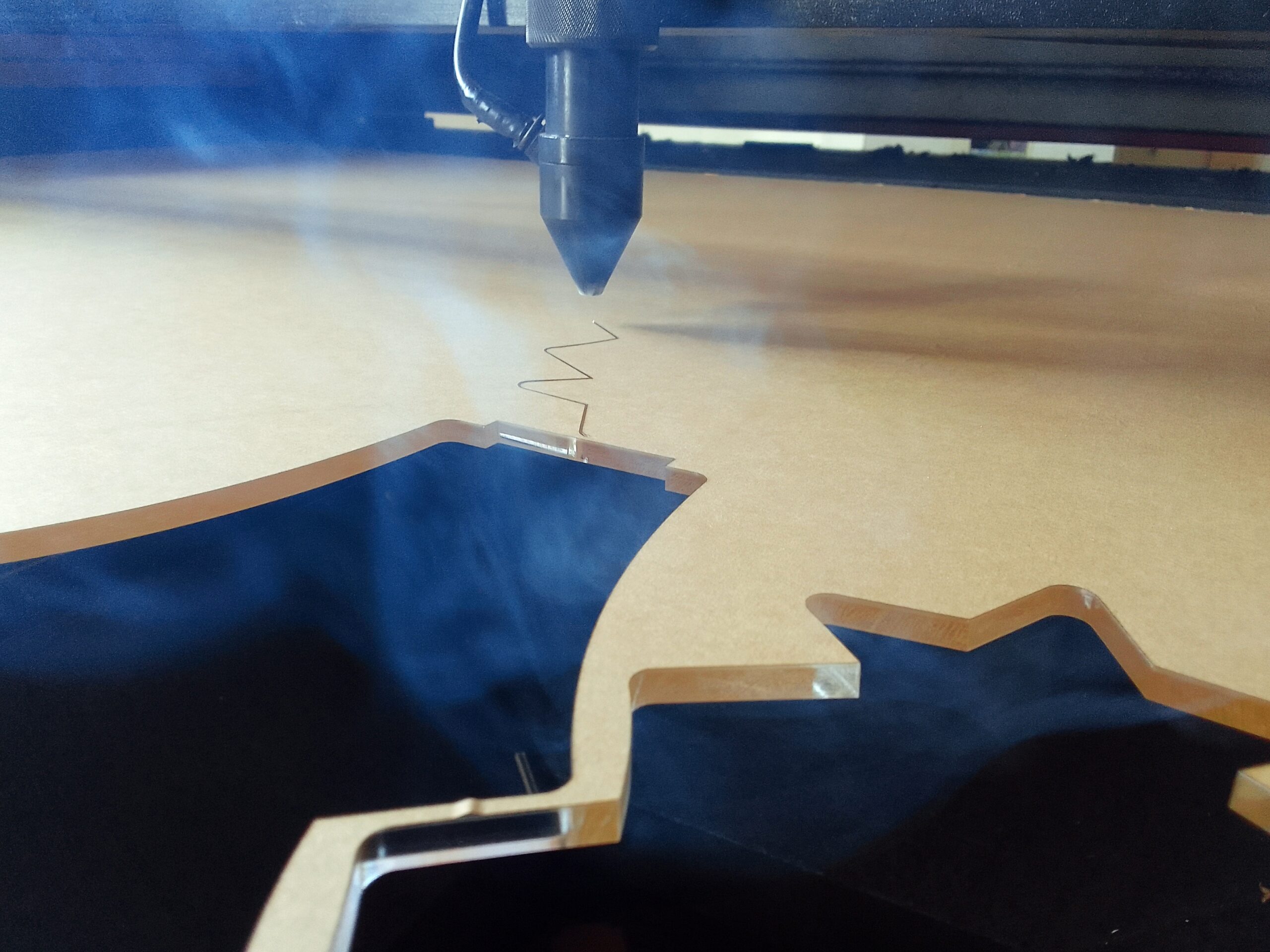laser cutting acrylic with fumes rising